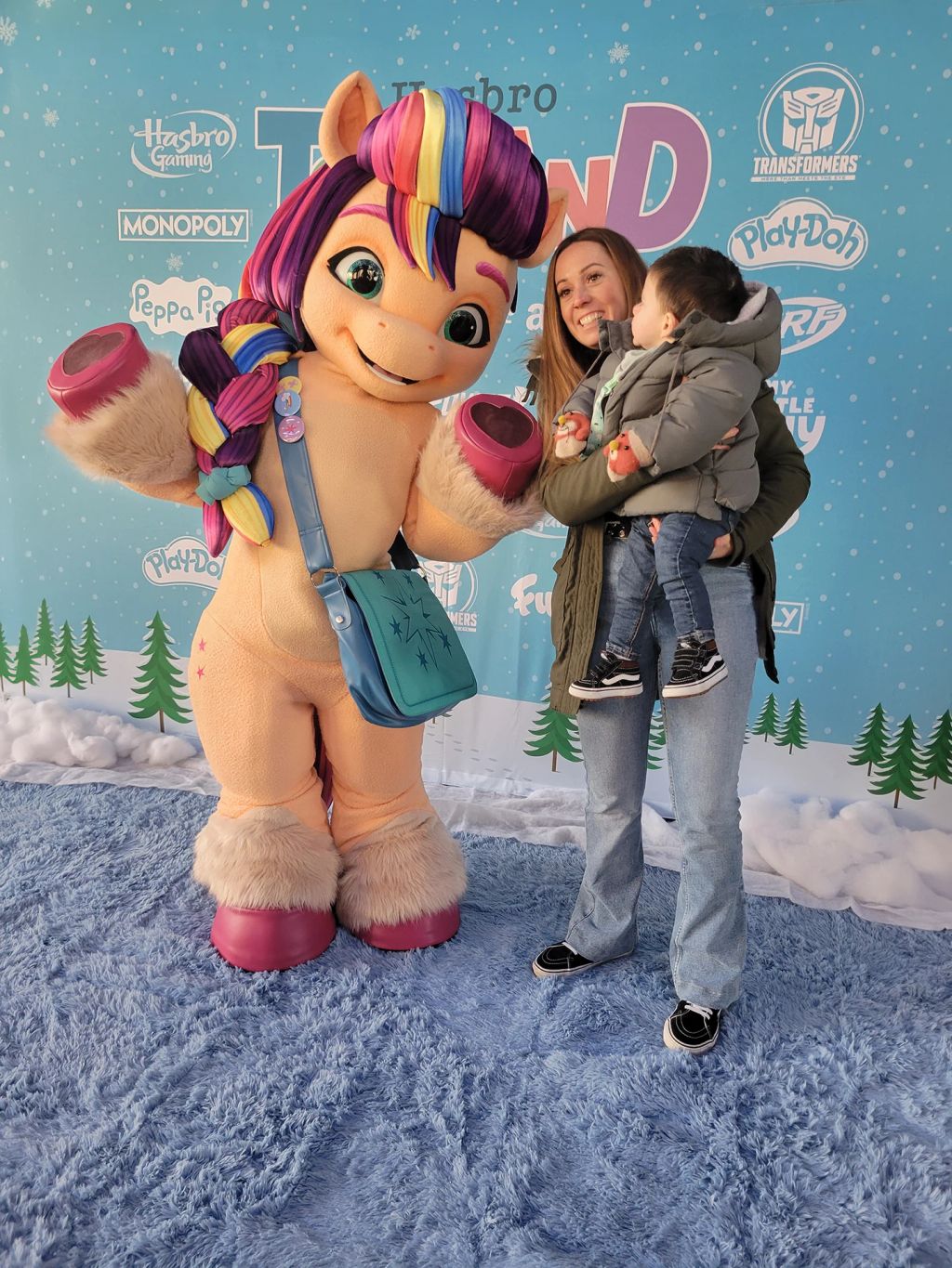 A young fan and mom pose with Sunny Starscout.