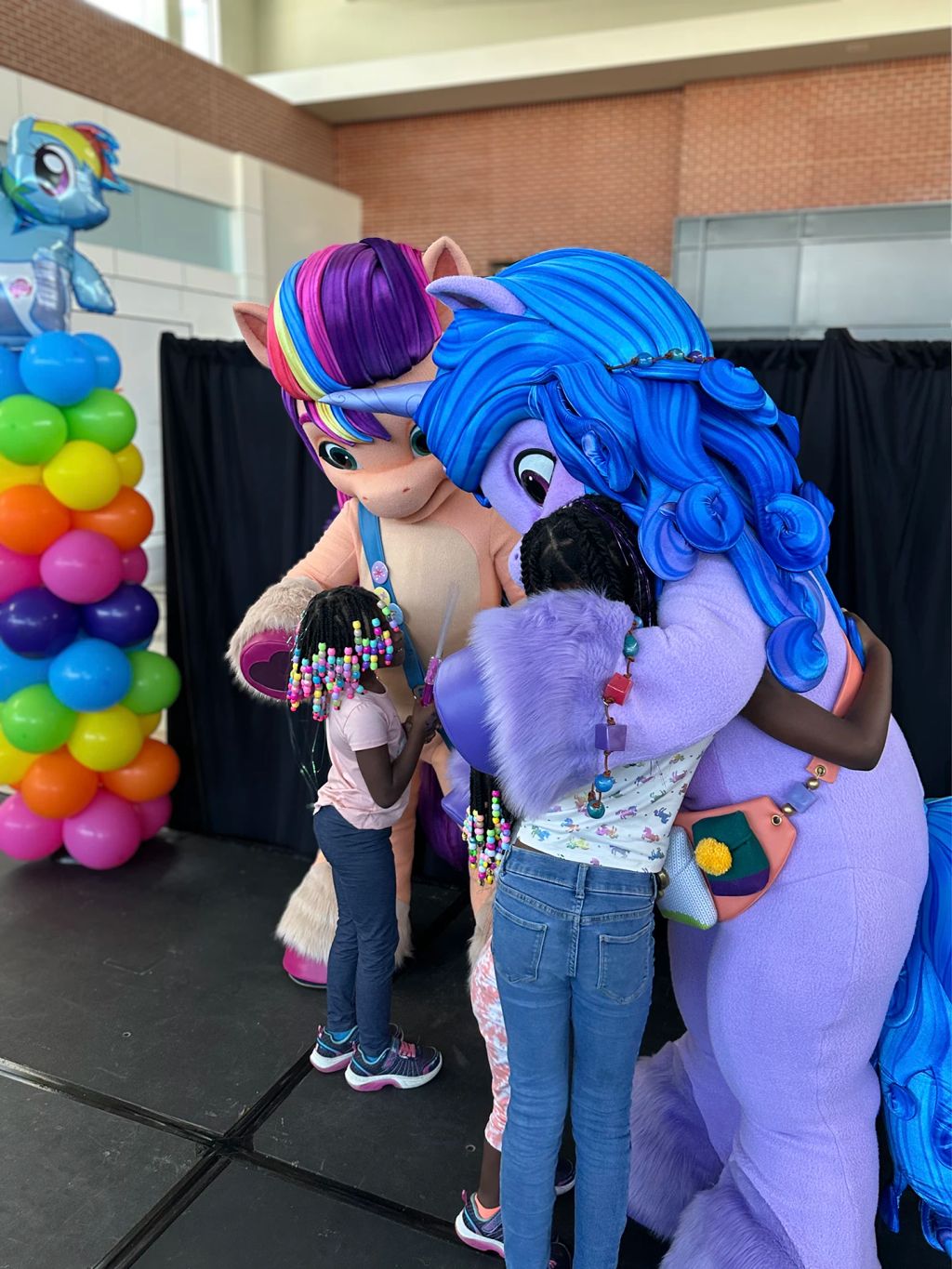 Sunny and Izzy hug their fans.